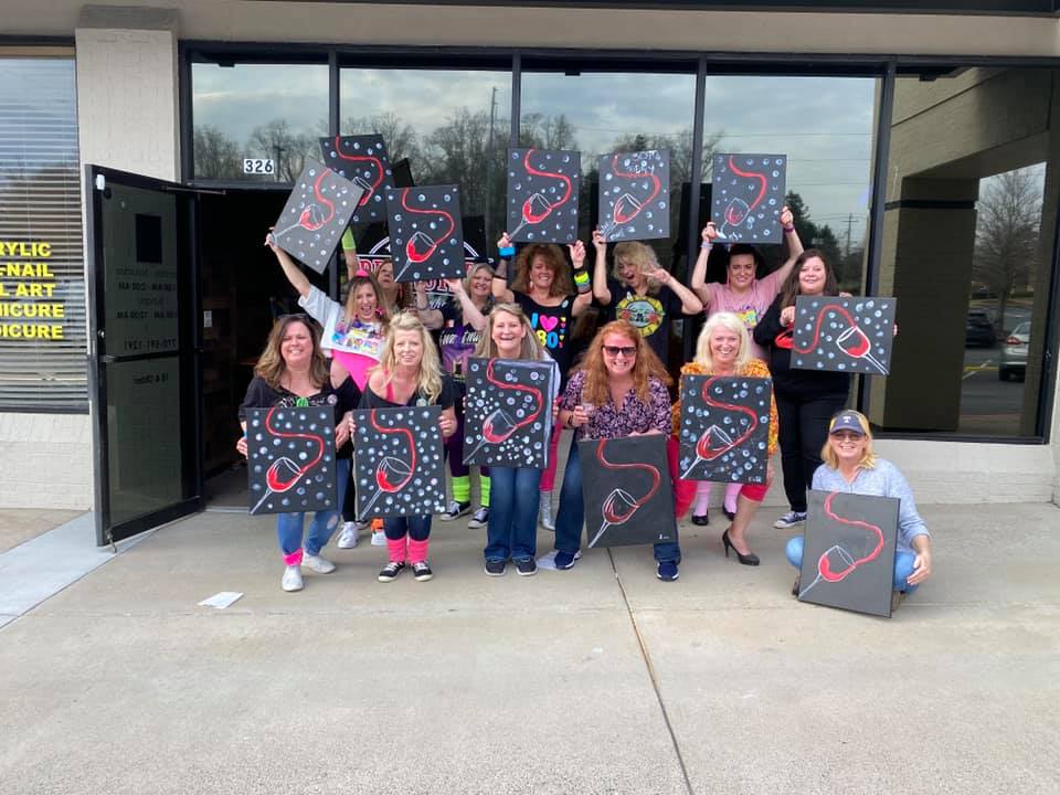 Large group paint party with wine glass canvases